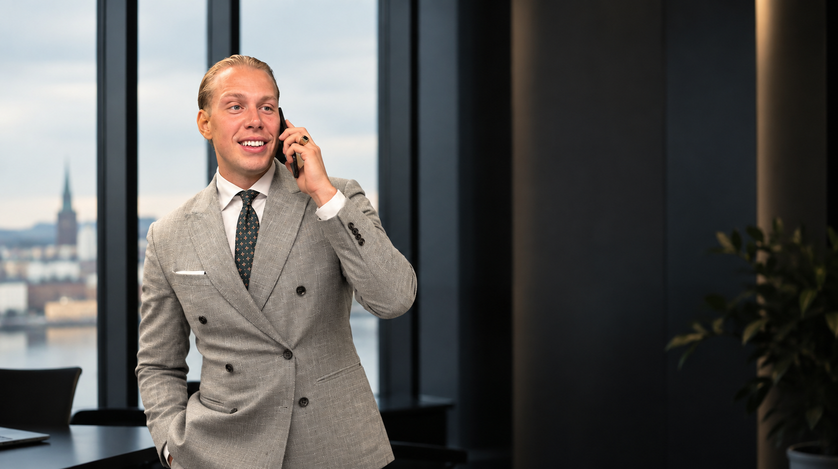 Henri Vartiainen on the phone at the office